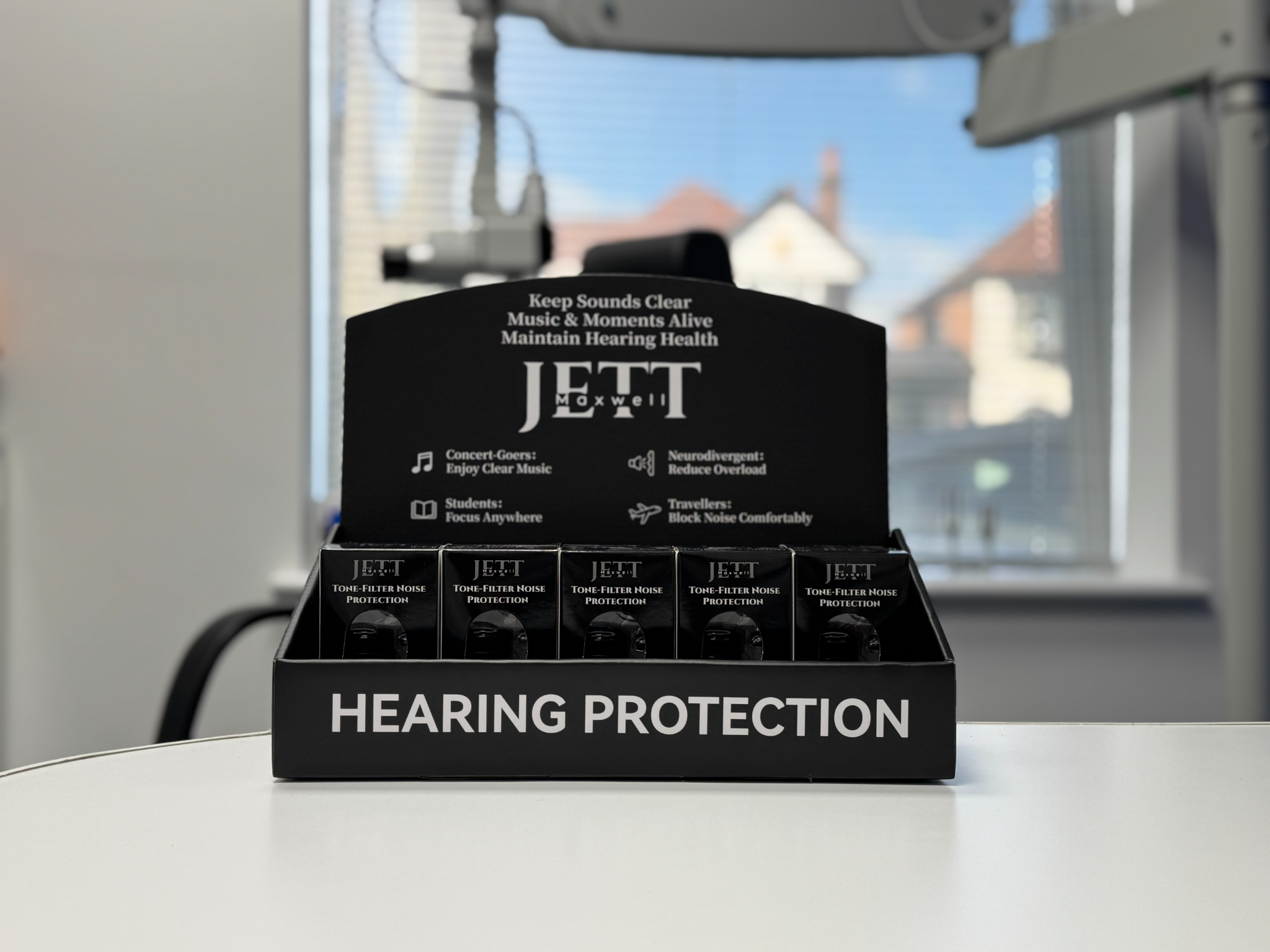 Jett Maxwell Tone-Filter boxes arranged in a countertop display at a hearing clinic
